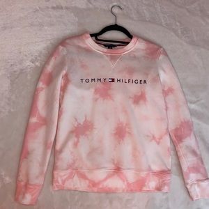 A pink and white tommy hilfiger crewneck.